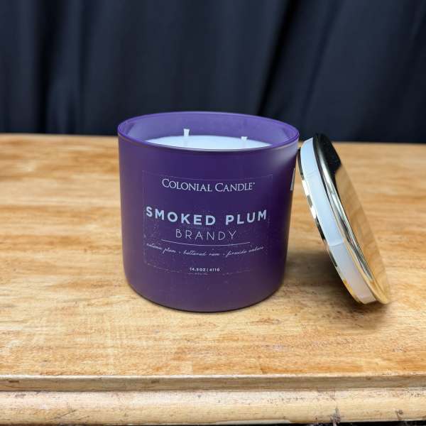 Purple scented candle in a glass jar with a metal lid