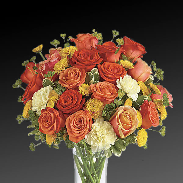Orange and yellow rose bouquet in a clear glass vase