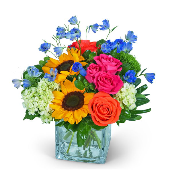 Mixed bouquet with sunflowers, roses, hydrangeas, and blue flowers in a glass vase
