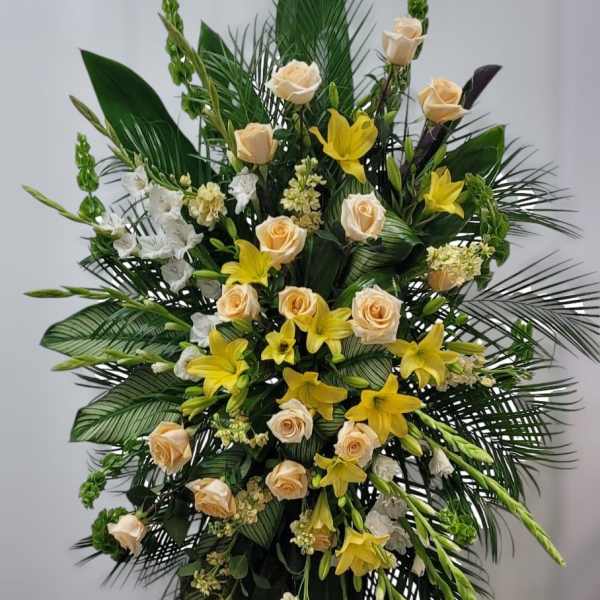 Tall floral spray with cream roses and yellow lilies