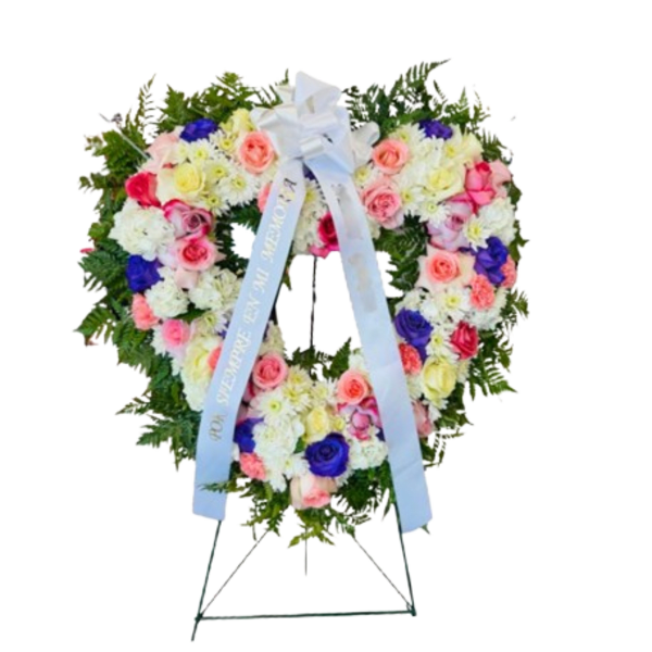 Heart-shaped floral wreath on a standing easel with a blue ribbon