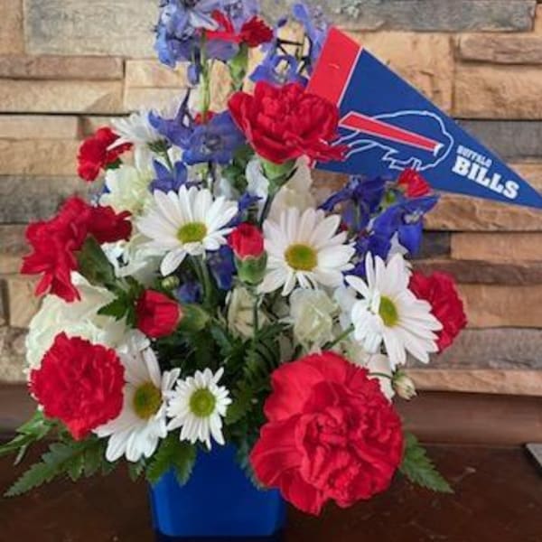 Bouquet of red, white, and blue flowers with a Buffalo Bills pennant