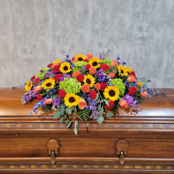 Colorful floral spray on a wooden casket