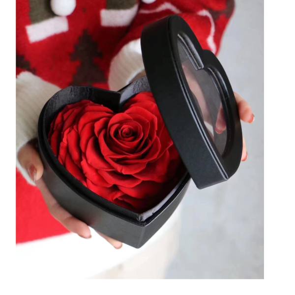 Red rose in a black heart-shaped gift box