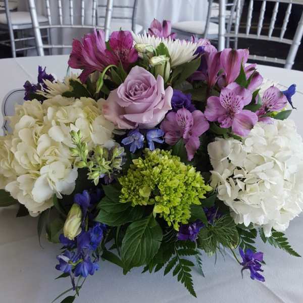 Mixed bouquet with hydrangeas, roses, and purple flowers on a table