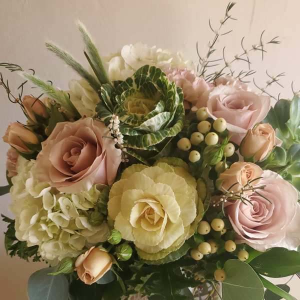 Bouquet of pale pink roses, white hydrangea, and green cabbage roses