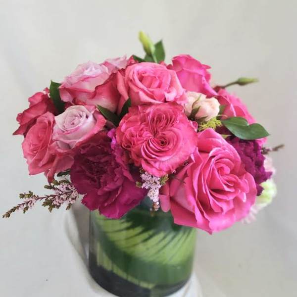 Pink roses arranged in a glass vase