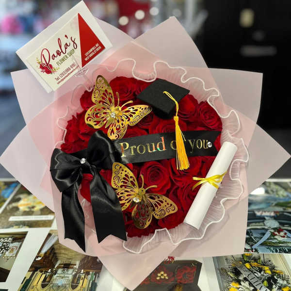 Red rose bouquet with a graduation cap, diploma, and black ribbon