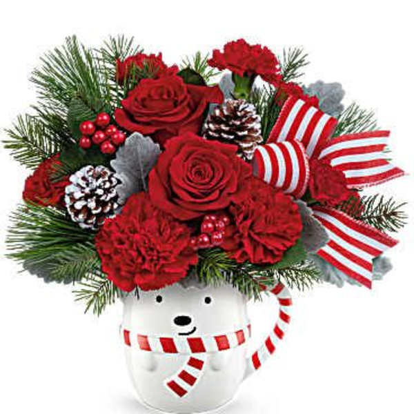 Red roses and carnations in a snowman vase with pinecones and striped ribbon