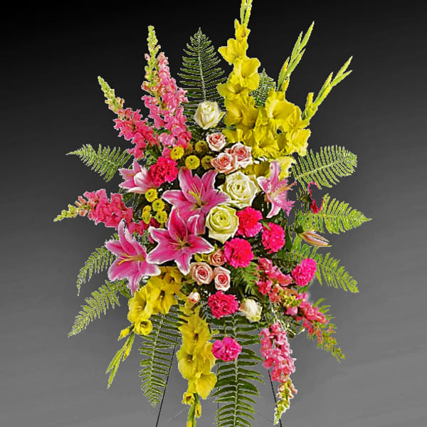 Tall standing floral spray with pink, yellow, and white blooms
