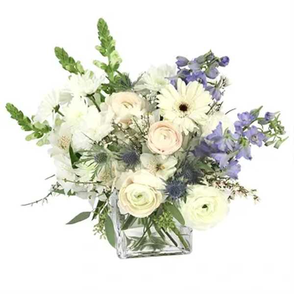 White and lavender bouquet in a clear square vase