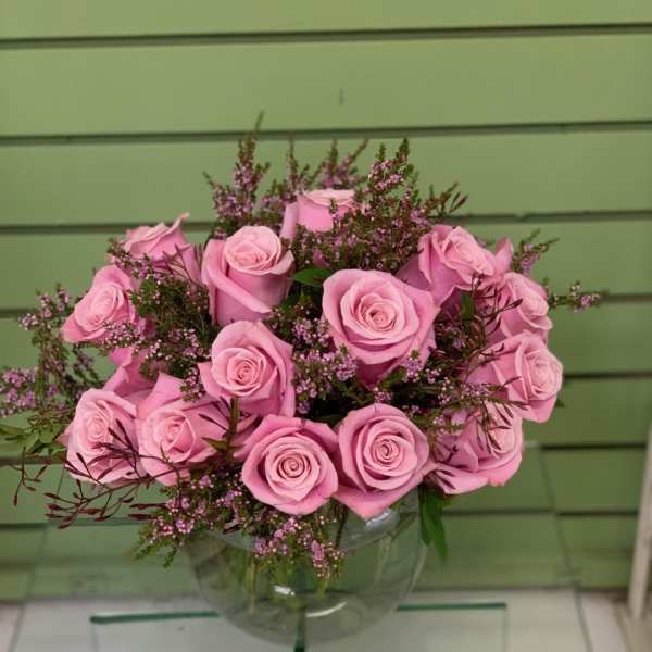 Pink roses arranged in a clear glass vase