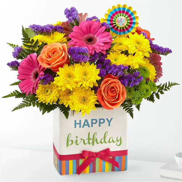 Bright mixed bouquet in a birthday gift box with a ribbon