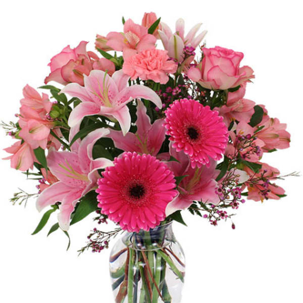 Pink mixed flower bouquet in a clear glass vase