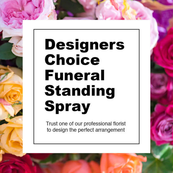 Sign reading Designers Choice Funeral Standing Spray over pink and orange roses