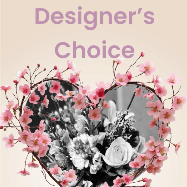 Heart-shaped floral design with pink blossoms around a black-and-white bouquet