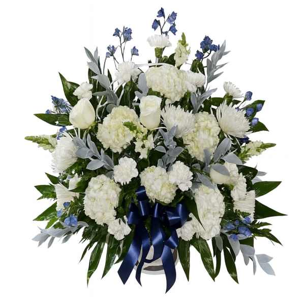 White floral spray with blue accents and a navy ribbon