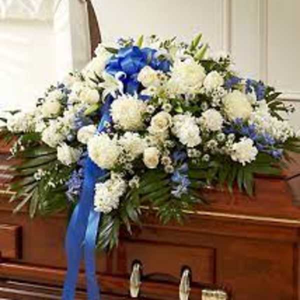 White and blue funeral spray on a casket