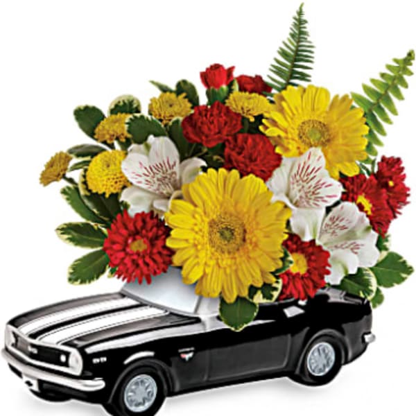 Black toy car topped with a colorful flower arrangement