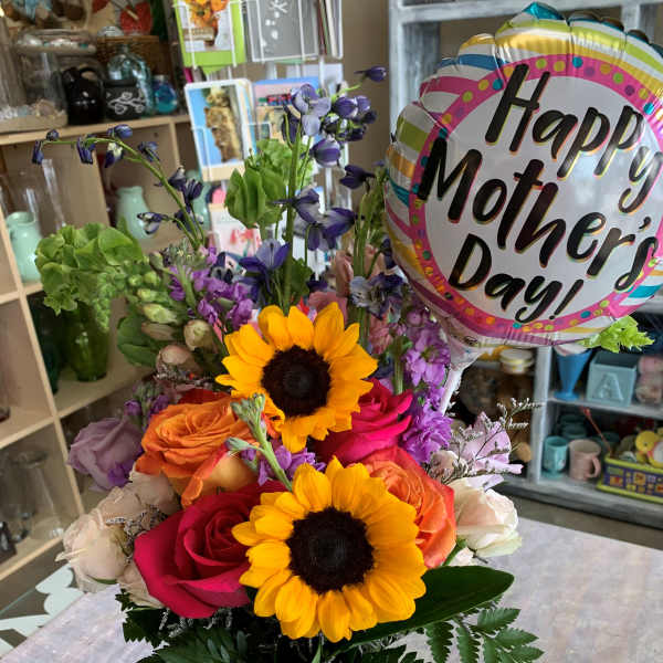 Mixed bouquet in a glass vase with a Mother's Day balloon