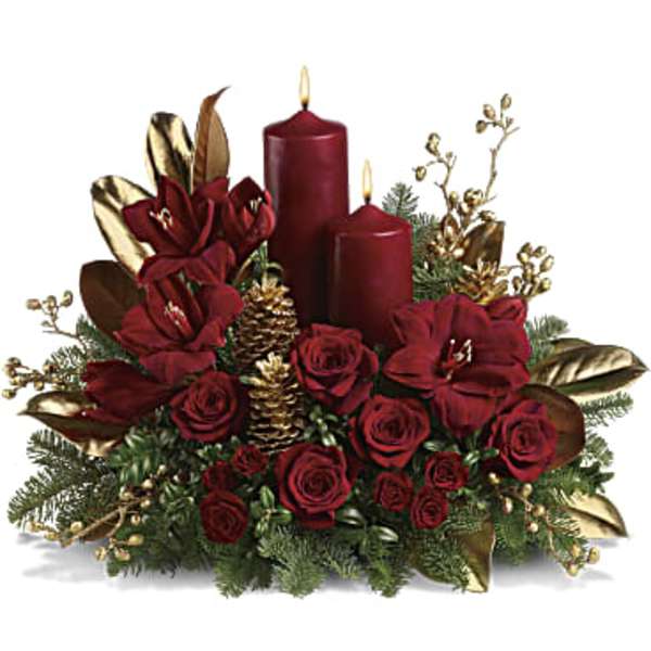 Red roses with two burgundy candles and gold accents in a holiday centerpiece