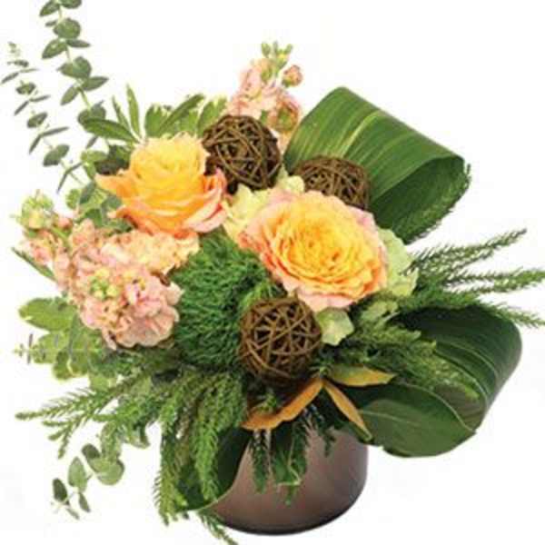 Bouquet of peach roses and pink flowers in a brown vase
