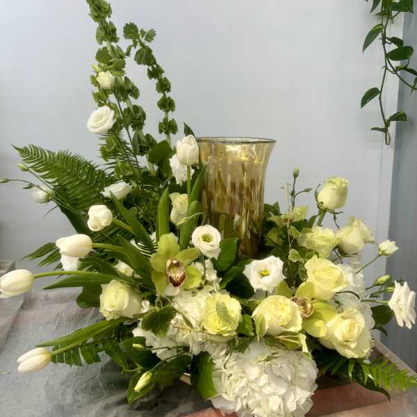White and pale yellow floral arrangement with a gold vase centerpiece