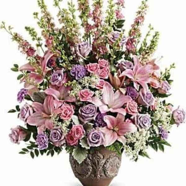 Pink and lavender floral arrangement in a decorative vase