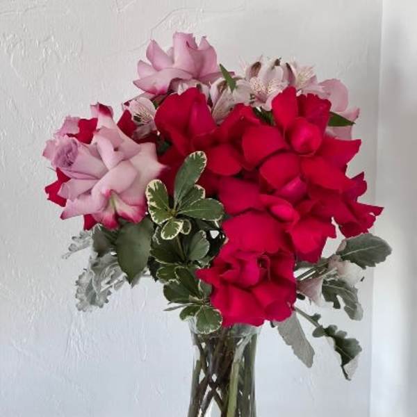 Bouquet of red and pink roses in a clear glass vase