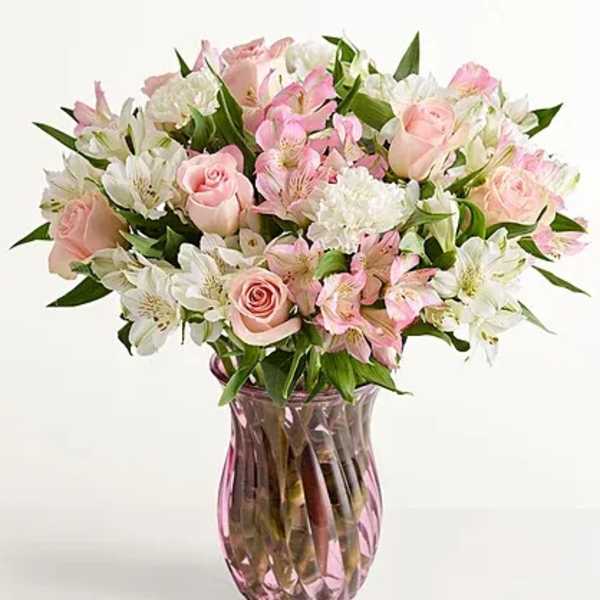Pink and white mixed bouquet in a pink glass vase