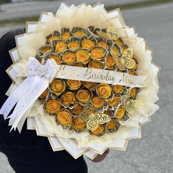 Yellow rose bouquet with dollar bills, ribbon, and butterfly decorations