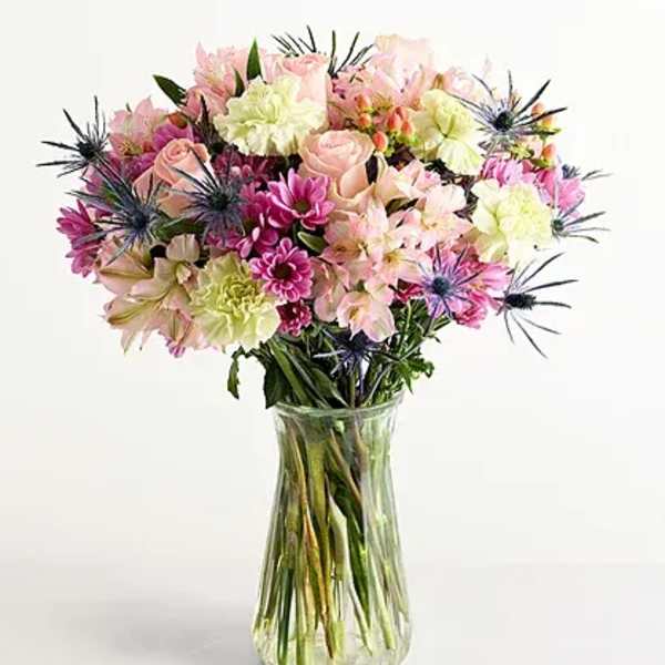 Mixed pink and cream bouquet in a clear glass vase