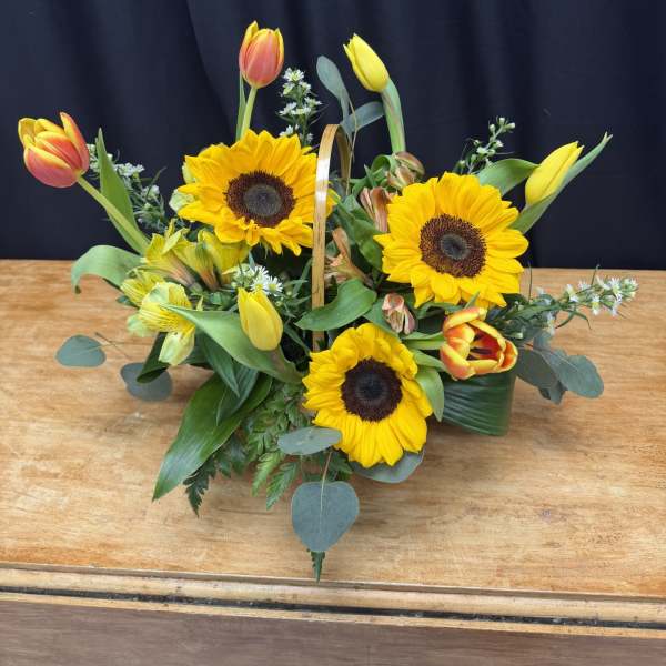 Basket arrangement with sunflowers and tulips
