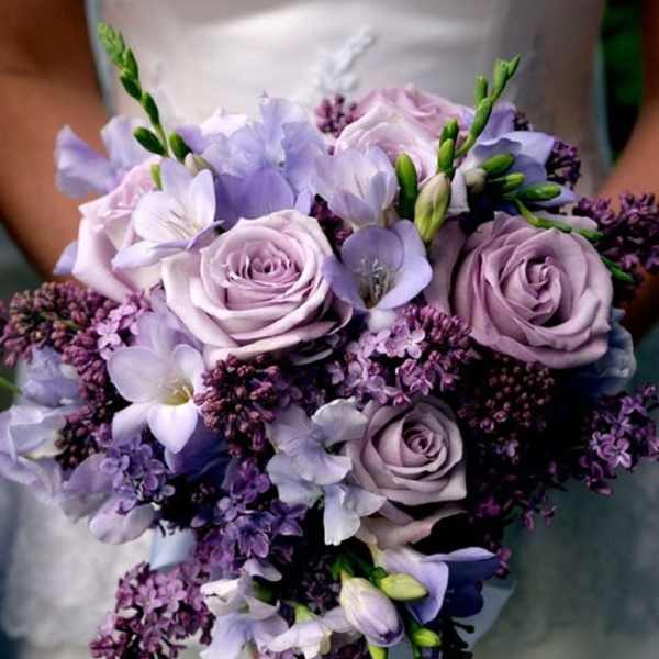 Lavender and white bridal bouquet with roses and small purple flowers