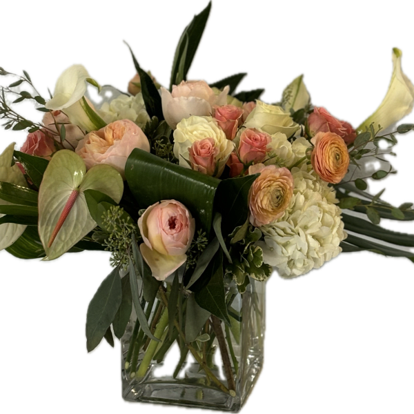 Pastel bouquet of roses, calla lilies, and hydrangeas in a glass vase
