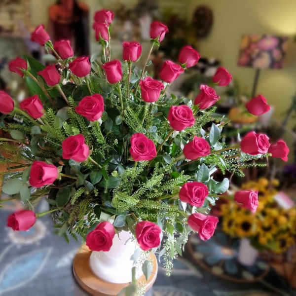 Bouquet of hot pink roses in a white vase