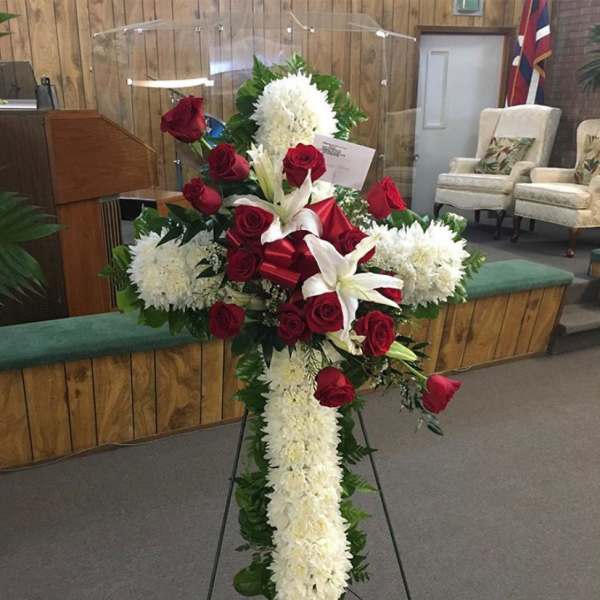 Standing floral cross with red roses and white flowers