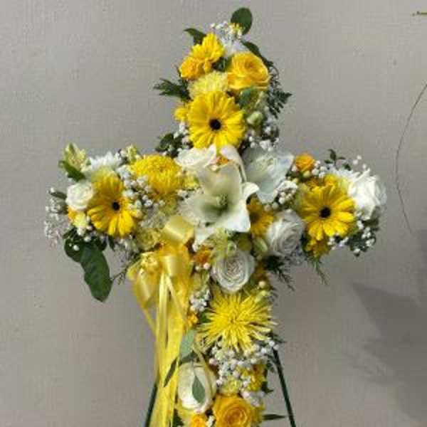 Yellow and white floral standing cross on an easel