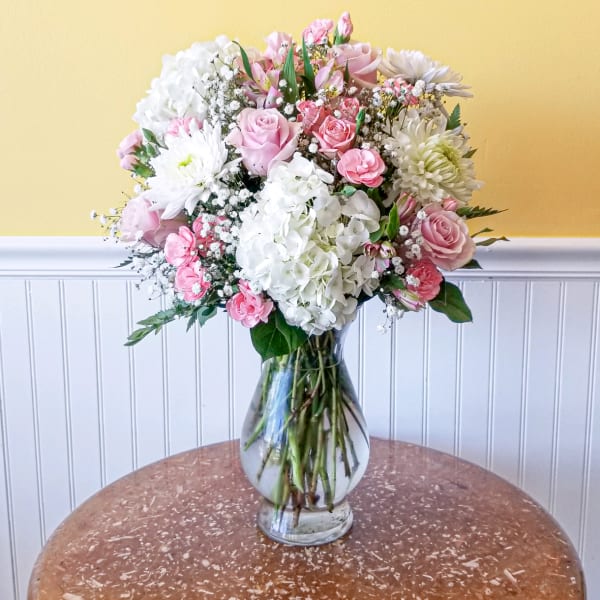 Pink and white mixed flower bouquet in a clear glass vase