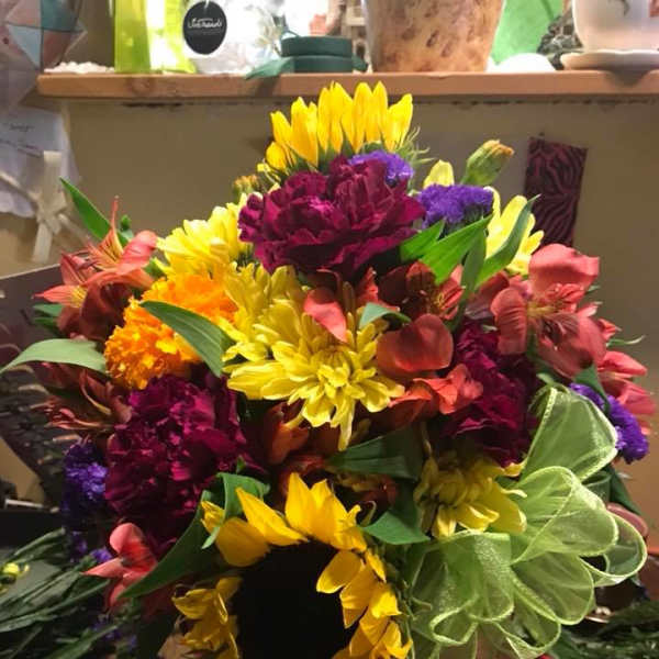 Bright mixed bouquet with sunflowers, carnations, and purple flowers