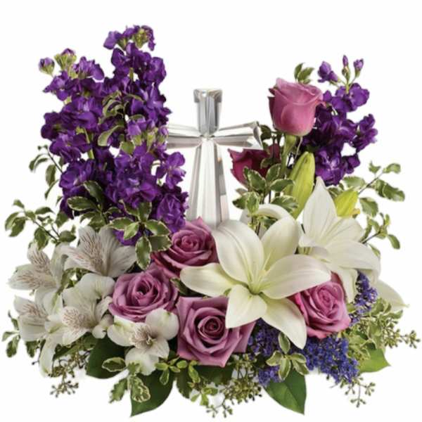Purple and white floral arrangement with roses, lilies, and a silver cross