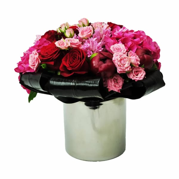 Pink and red rose bouquet in a silver vase with black ribbon