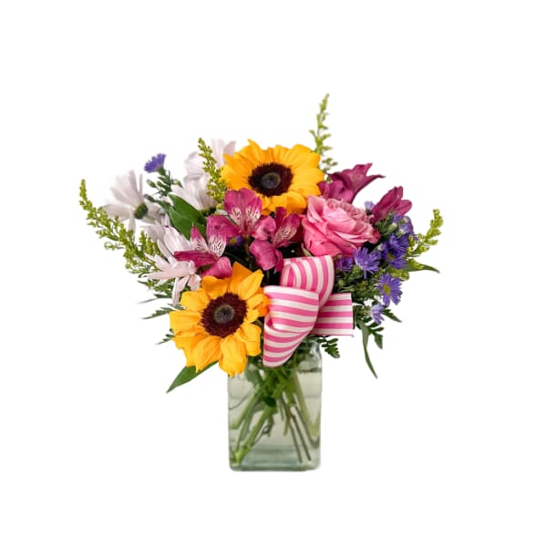 Mixed bouquet with sunflowers, pink roses, and purple flowers in a glass vase