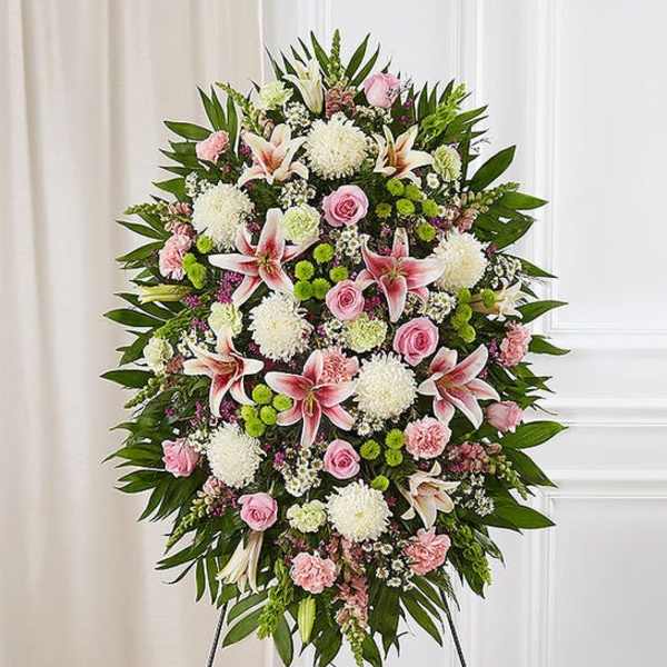 Standing floral spray with pink lilies, roses, and white mums