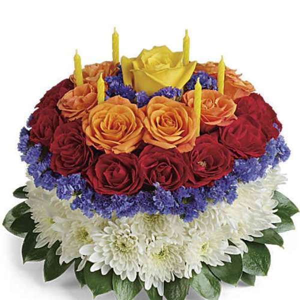 Round floral cake with roses and candles