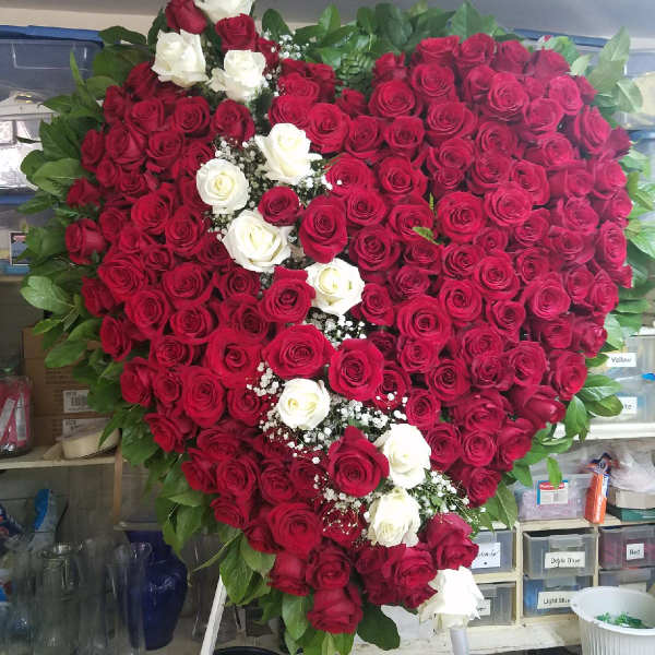 Heart-shaped rose arrangement with red and white roses