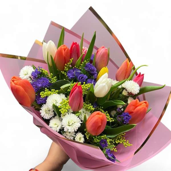 Bouquet of multicolored tulips with white and purple filler flowers