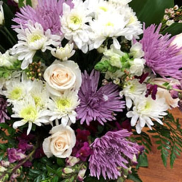 Bouquet of white and lavender flowers with cream roses