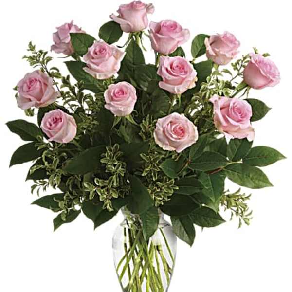 Arrangement of light pink roses in a clear glass vase