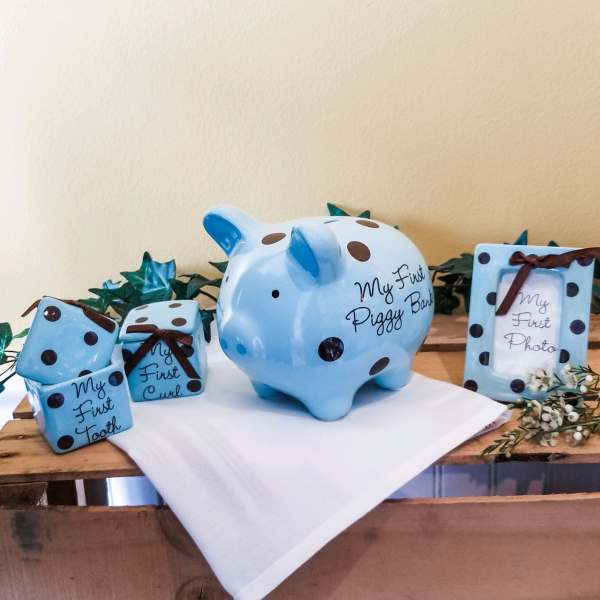 Blue polka-dot baby keepsakes on a wooden table